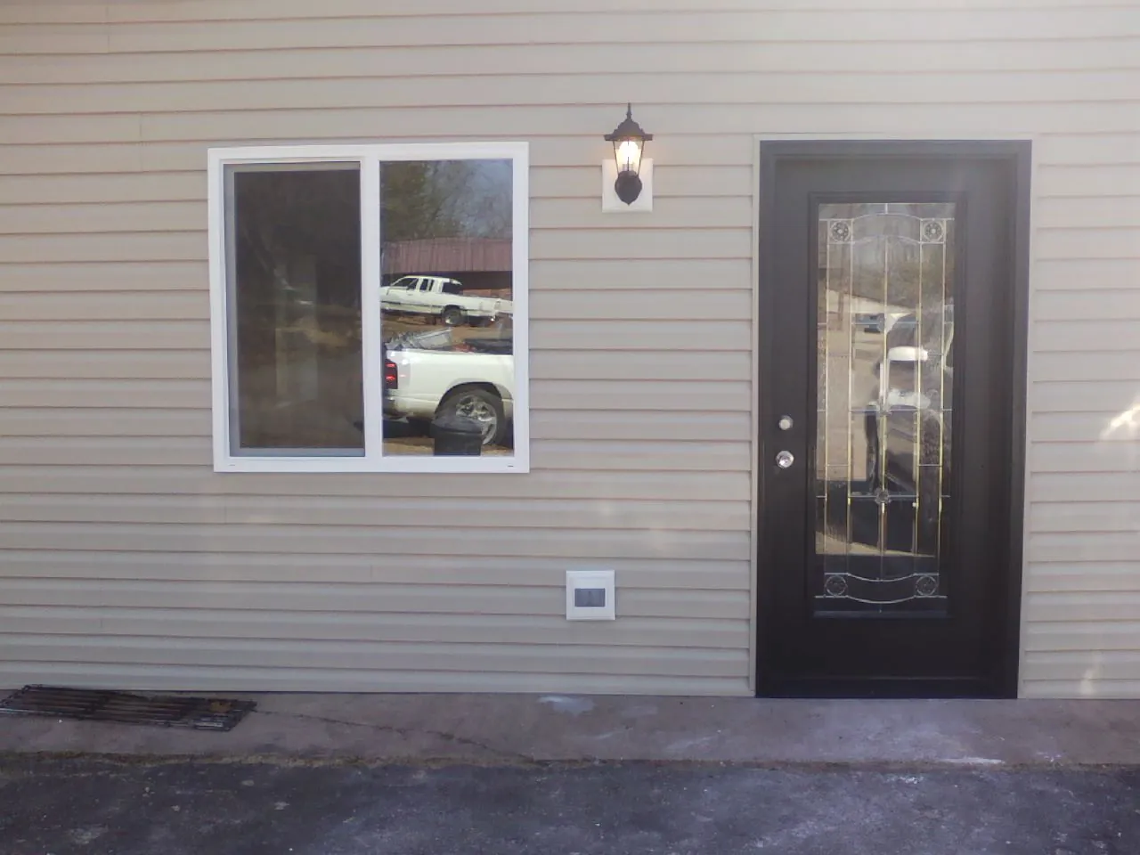 New siding, window and entry door on the side of an addition in Neversink
