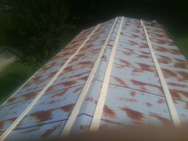 Rusted metal roof panels with new wood purlins before replacement — Storm Damage Roof Repair in Neversink by Roofing Brothers